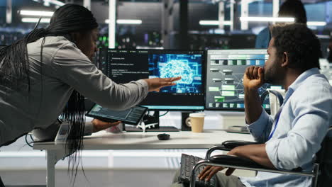 admin in wheelchair and data center coworker work together using node tree tool