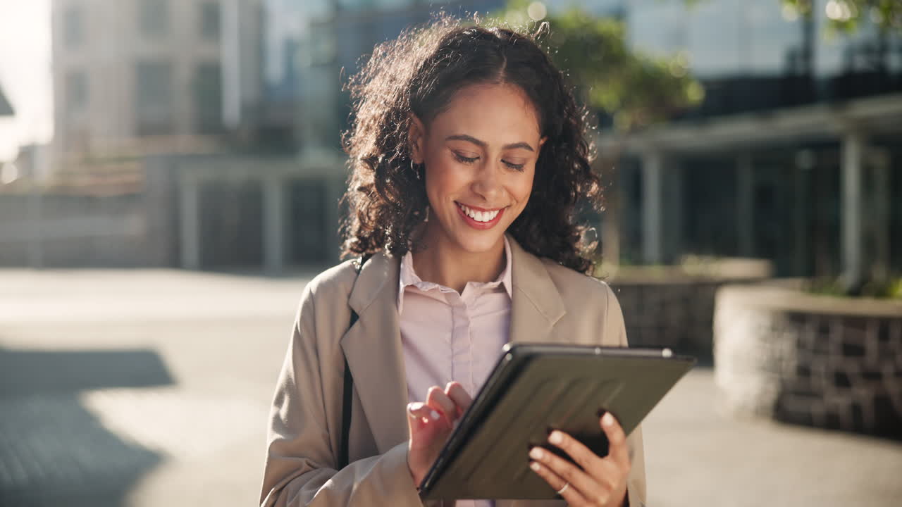 Businesswoman using tablet outdoors