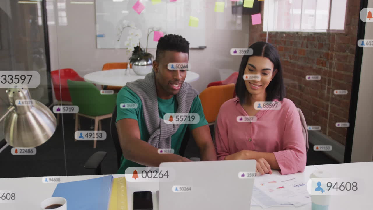 Collaborating at office desk, diverse colleagues with animation of social media notifications