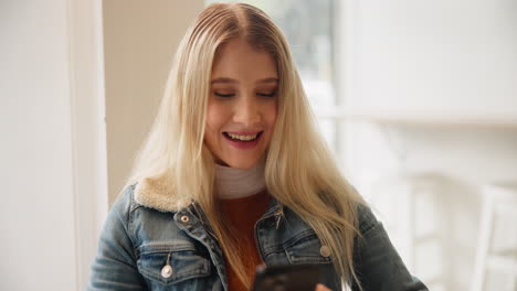 a woman with blonde hair wearing a denim jacket