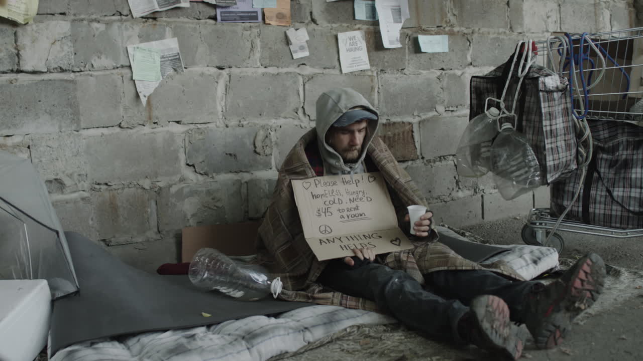 Homeless man holding a sign asking for help
