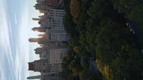 sun behind new york skyscrapers