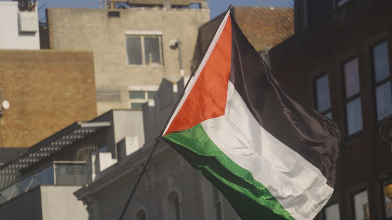 Palestine Gaza Flag Blowing Gently in Wind During Protest in Brighton City Centre. Symbol of Freedom and Independence for Palestinians After Years of War