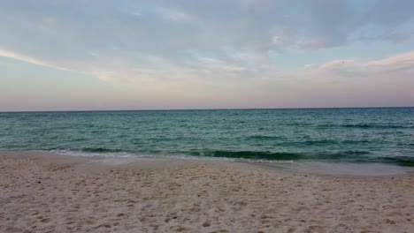 Drone-aerial-POV,-taking-off-from-the-beach-on-morning-dawn-time