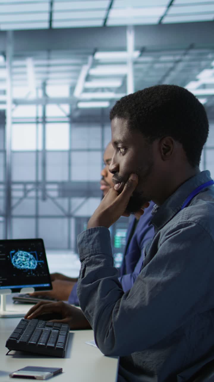 Vertical video Cheerful server room workers laughing together in office