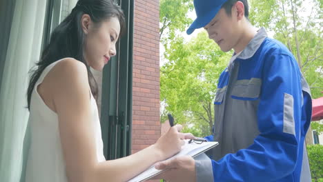 delivery man uniform smiles during express, courier holding a small package parcel delivering goods to customer's home with van truck, door-to-door services