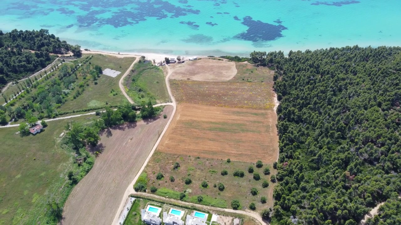 Turquoise Coastline with Rural Farmland, Forest and Seaside Villas in Greece, Aerial View