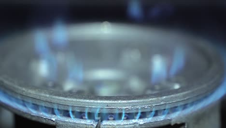 blue flame of the kitchen gas stove on a closer look. rising energy prices