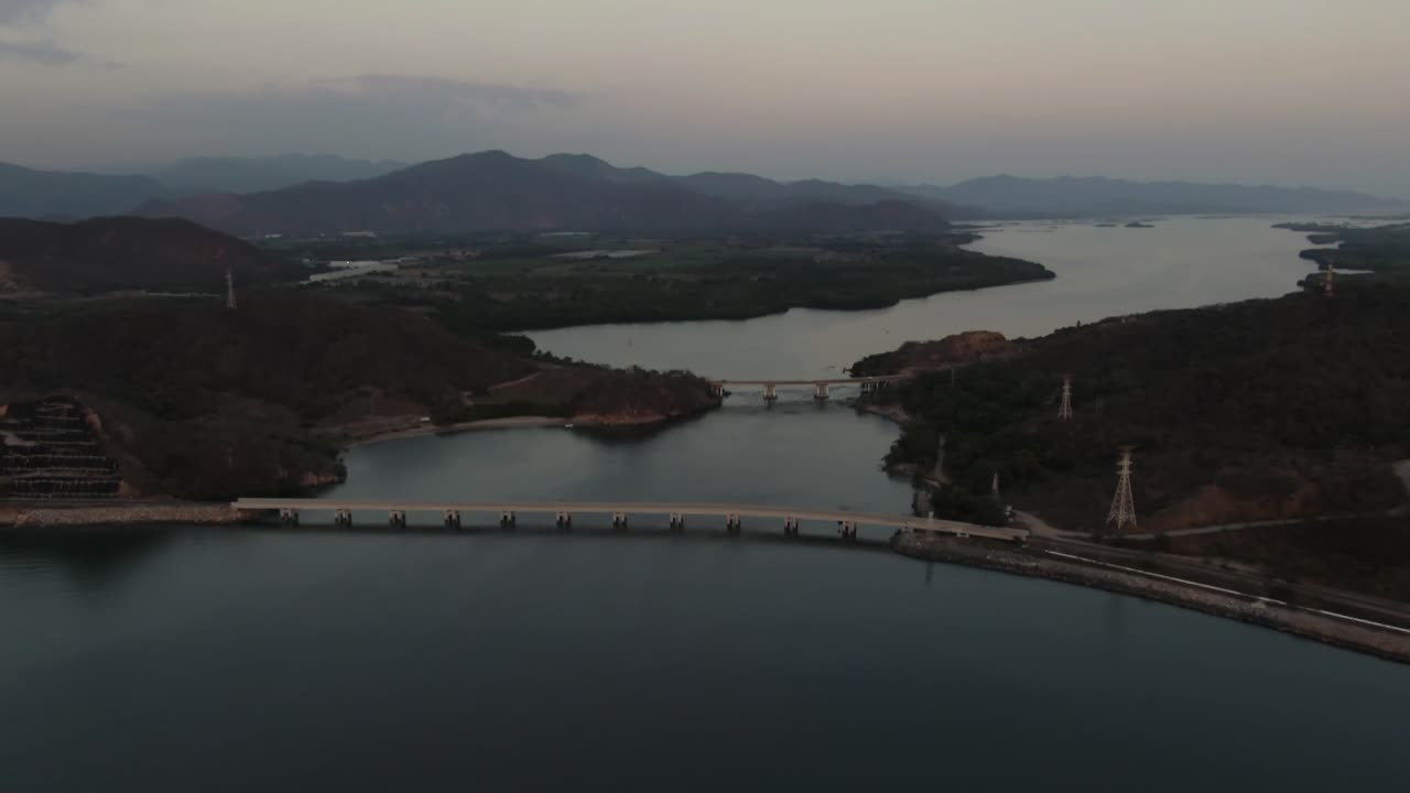 Tilt-up shot of Tepalcates II bridge and railroad crossing over Laguna de Cuyutlán, Manzanillo, Colima