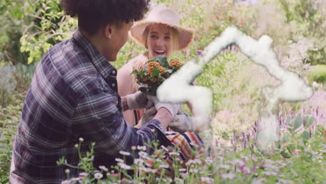 animation of cloud house over happy diverse couple planting flowers in sunny garden