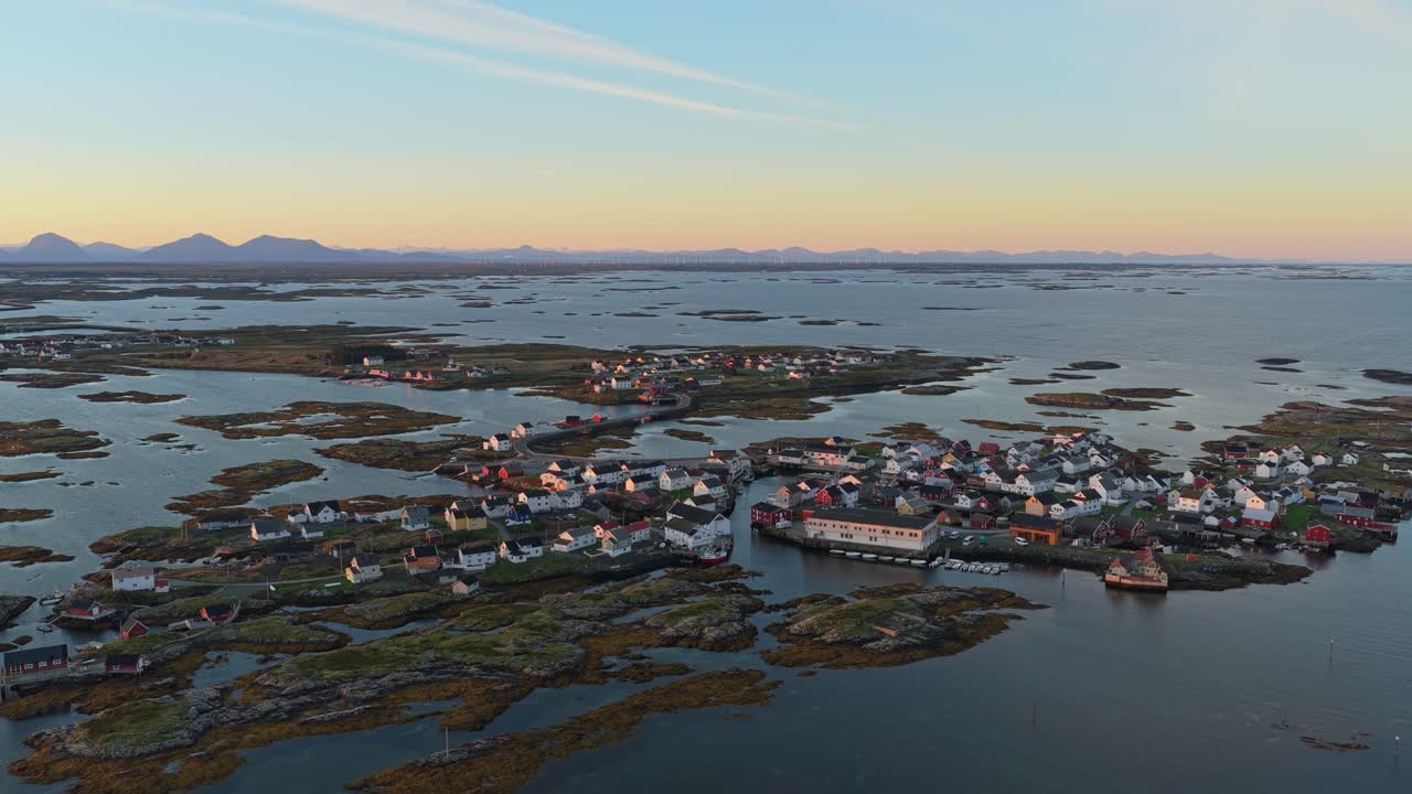 Kystbyen Veiholmen badet i gyldent lys ved daggry, luftfoto af Smøla ø