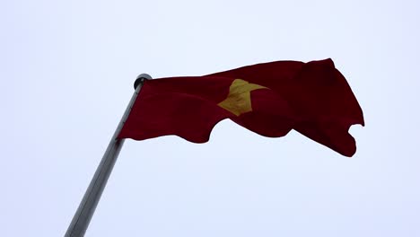 vietnamese flag waving on a flagpole in hanoi