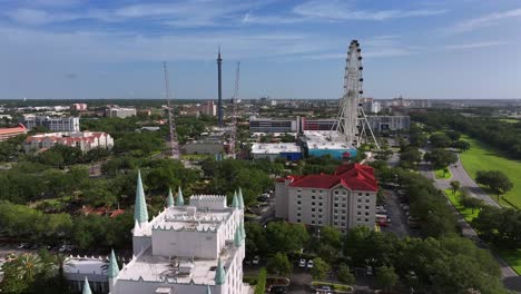 Aerial-flyover-Amusement-Park-in-Orlando-with-Castle-buildings-and-ferris-wheel-during-sunny-day