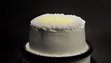 edam cheese cake with creme butter in a turn table loop black background tasty delicious treat