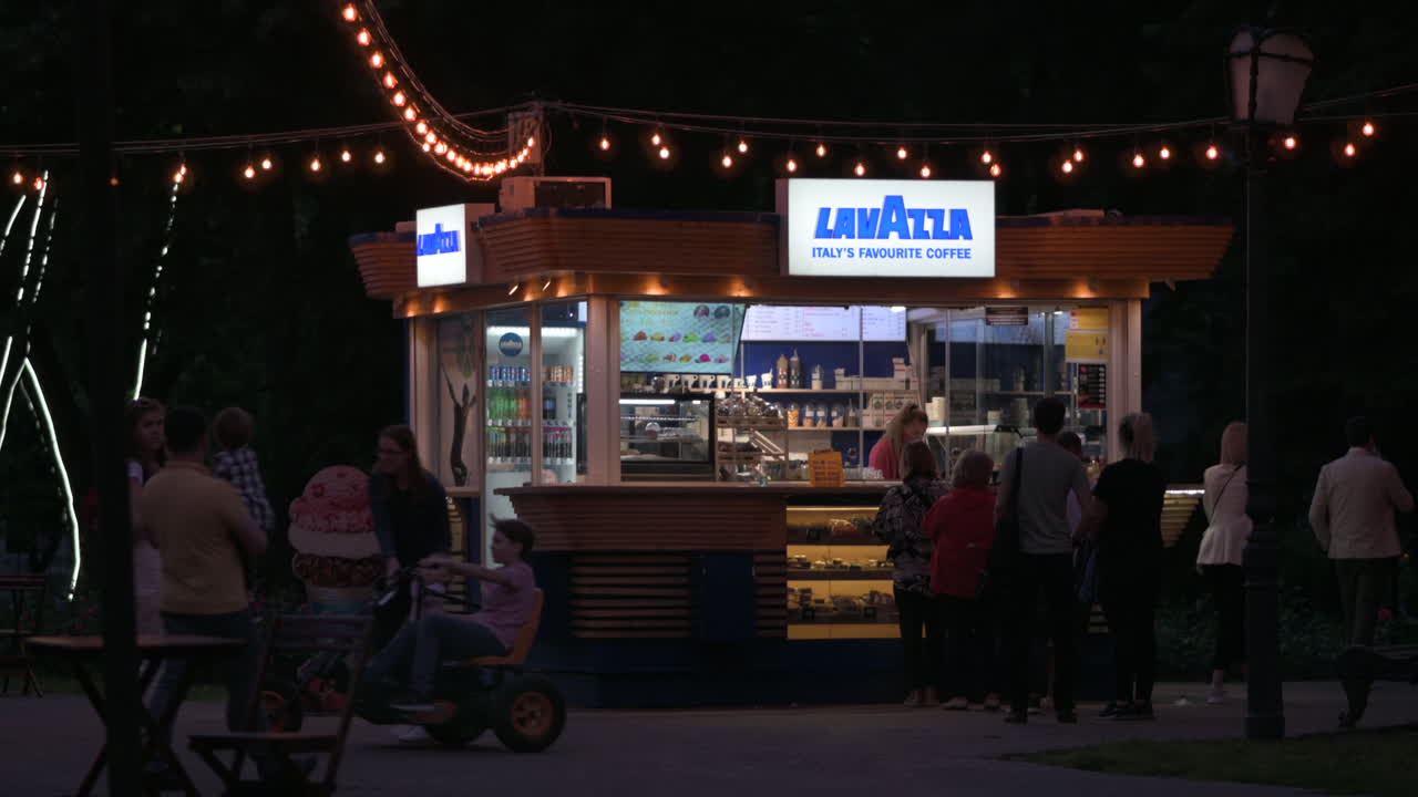 Chisinau, Moldova - June 5, 2021: People walking in front o a cafe at night