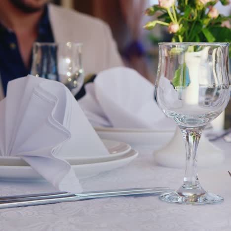 waiter serves wine in restaurant