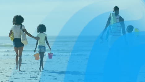 carrying colorful buckets, family walking on beach with blue animation overlay