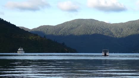 Golden-hour-view-of-light-and-shadow-as-boat-approaches-secluded-bay-on-calm-water---Camp-Bay,-Endeavour-Inlet
