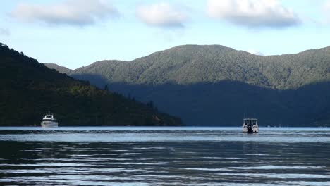 golden-hour view of light and shadow as boat approaches secluded bay on calm water - camp bay, endeavour inlet