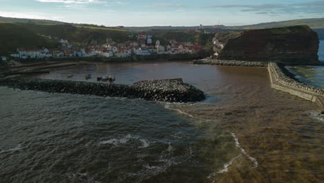 low establishing drone shot of staithes coastal village yorkshire uk