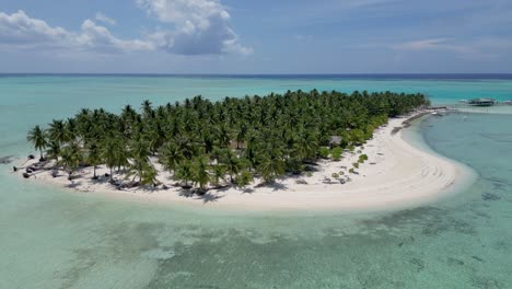 Panoramic-aerial-overview-of-entire-Onok-island-bungalows,-pier,-and-palm-trees-on-sandy-beach