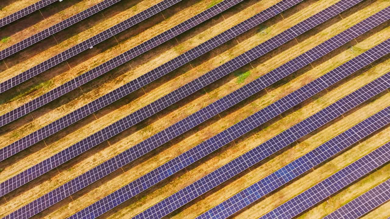 Cinematic top view captures structured solar grid glowing in warm sunlight
