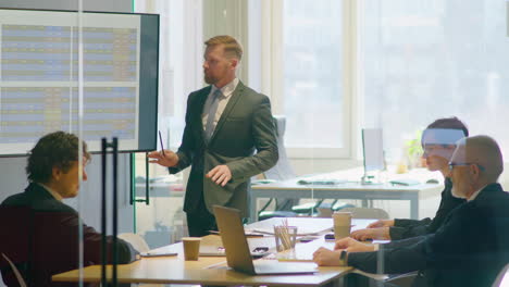 businessman giving presentation at office meeting