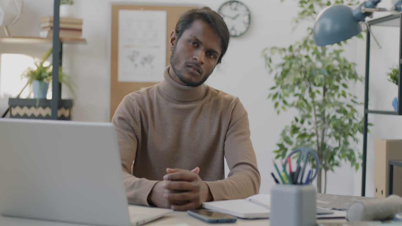 Man Sitting at a Desk in an Office