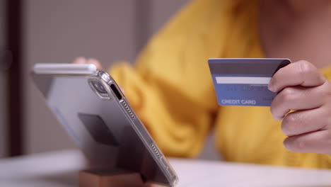 detail of a female hand making an online purchase with a credit card