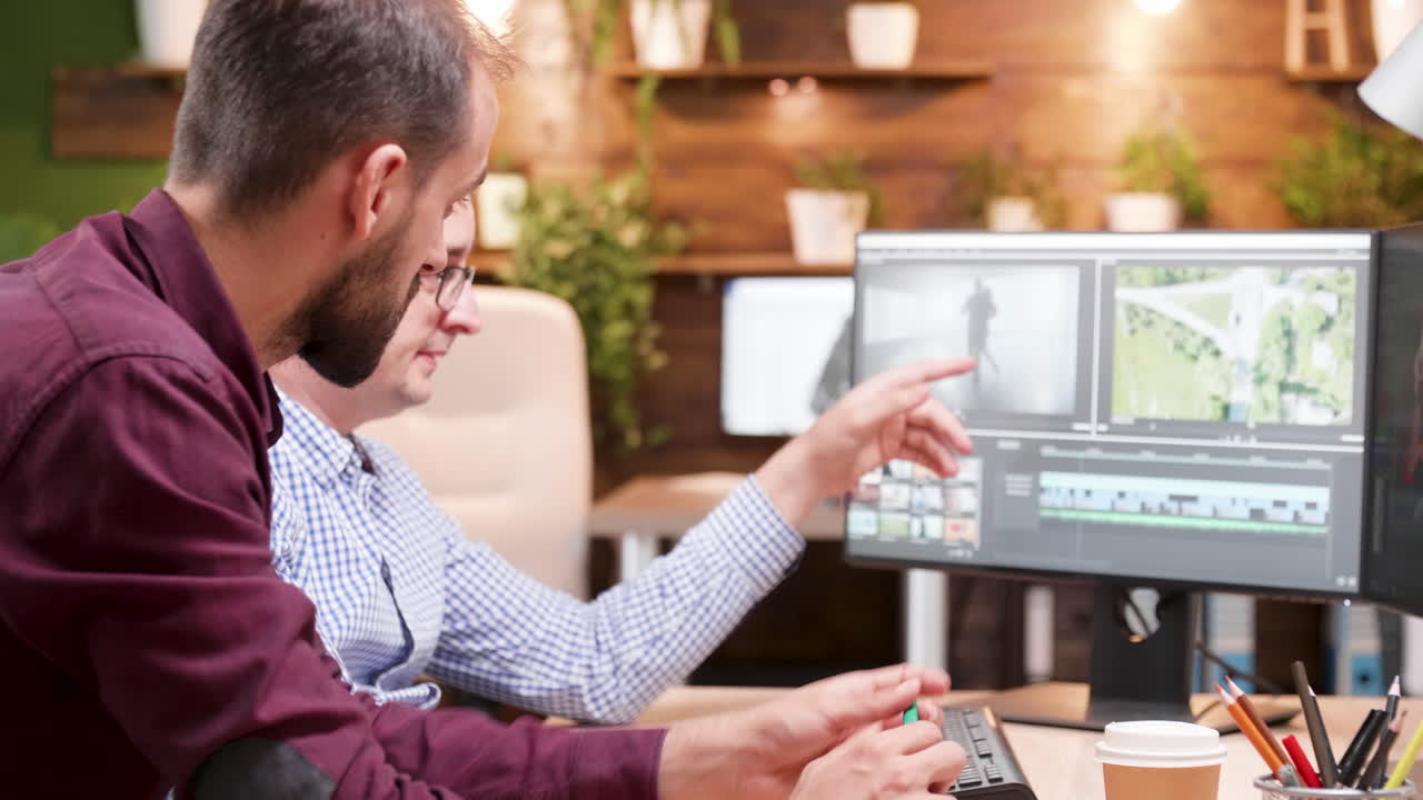 Two men working on video editing in the office