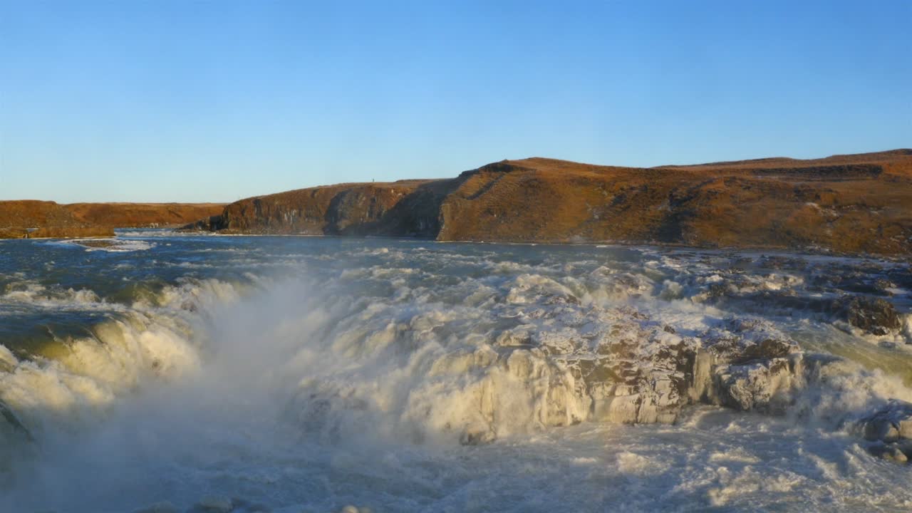 Aerial view of frozen Urriðafoss waterfall in Iceland with wild river