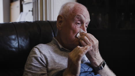 senior man suffering from cold or flu symptoms