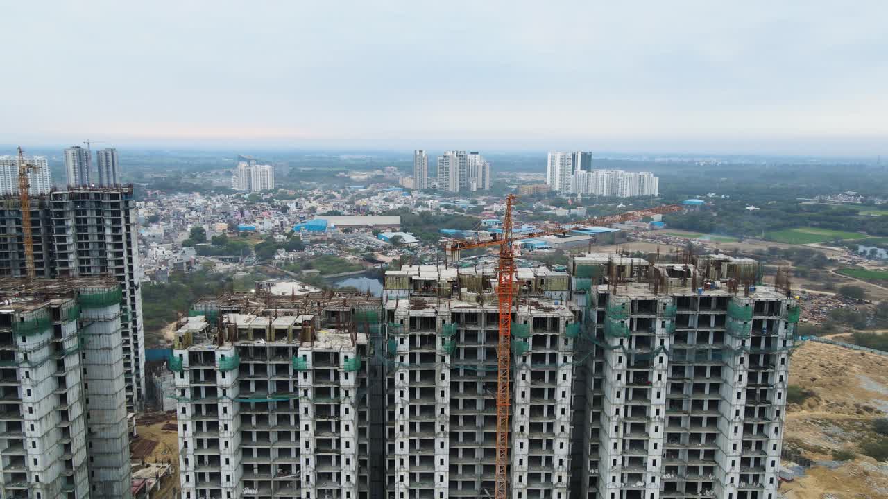 Aerial drone shot capturing a sprawling under-construction building near Dwarka Expressway, with cranes and scaffolding surrounding the structure.