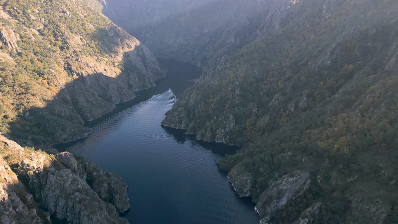 Sweeping drone overview of Cañón del Río Sil, Ribeira Sacra, Galicia, Spain, river bends through rocky cliffs