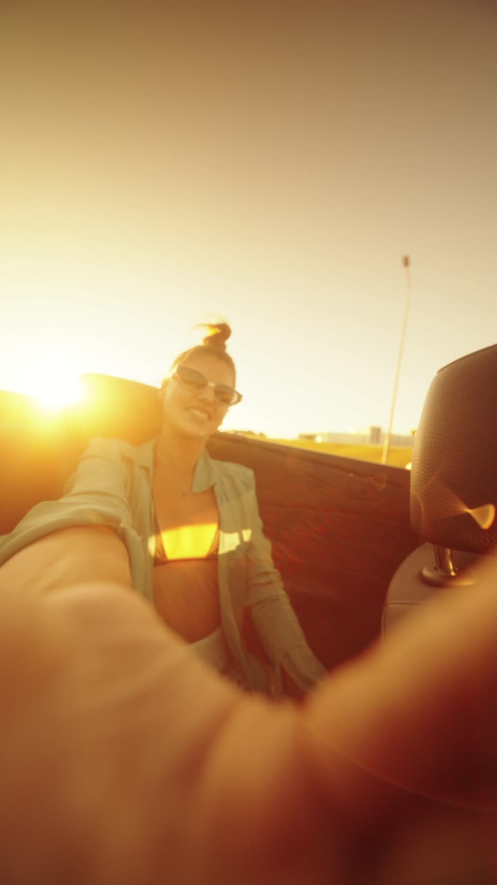 Woman on a road trip in a convertible during sunset