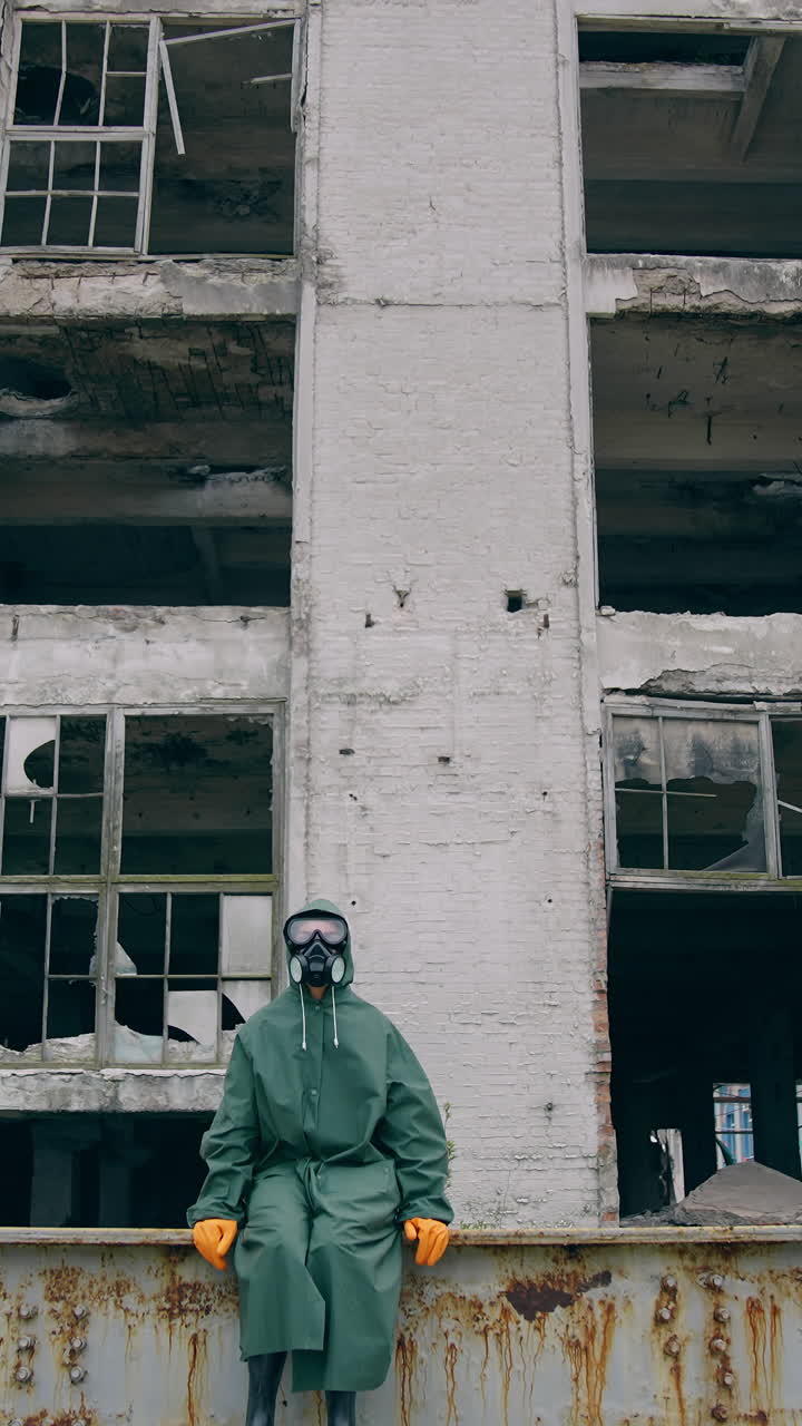 Survivor after nuclear chemical incident. Man in gas mask near abandoned destroyed building