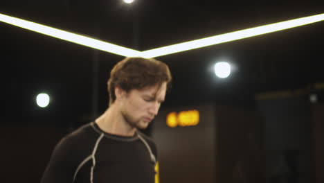 young sport man using jump rope in sport club. fitness man jumping at gym