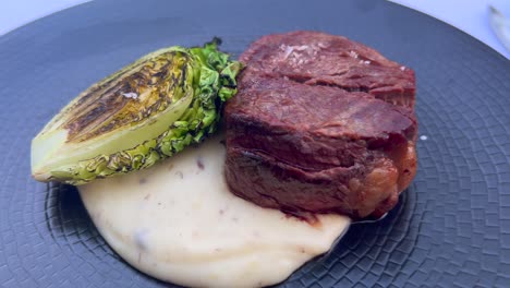 delicious beef steak with green cabbage and truffle mash potatoes in a fancy restaurant, entrecote filet meat, food 4k shot