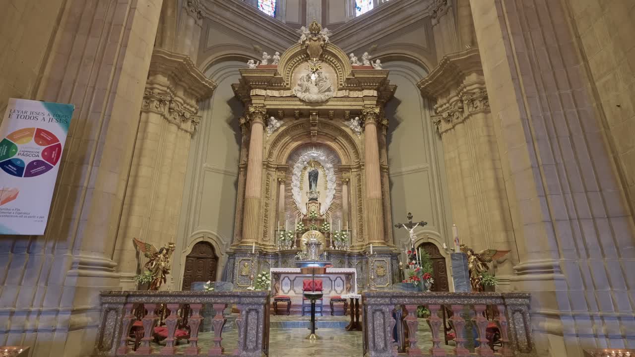 Wide shot of decorated baroque altar and Virgin Mary statue in Portugal