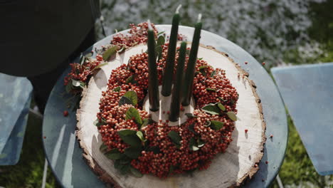 rustic autumn wreath with candles on a wooden slice