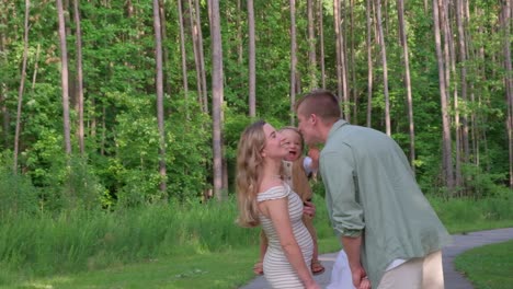 a heartfelt video of a loving couple and their joyful family moments a touching video shows a loving couple sharing a kiss in the woods and later embracing their baby at a park celebrating family life