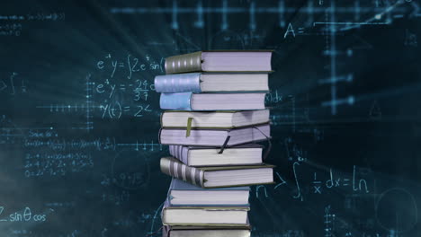 pilas de libros y ecuaciones matemáticas y gráficos