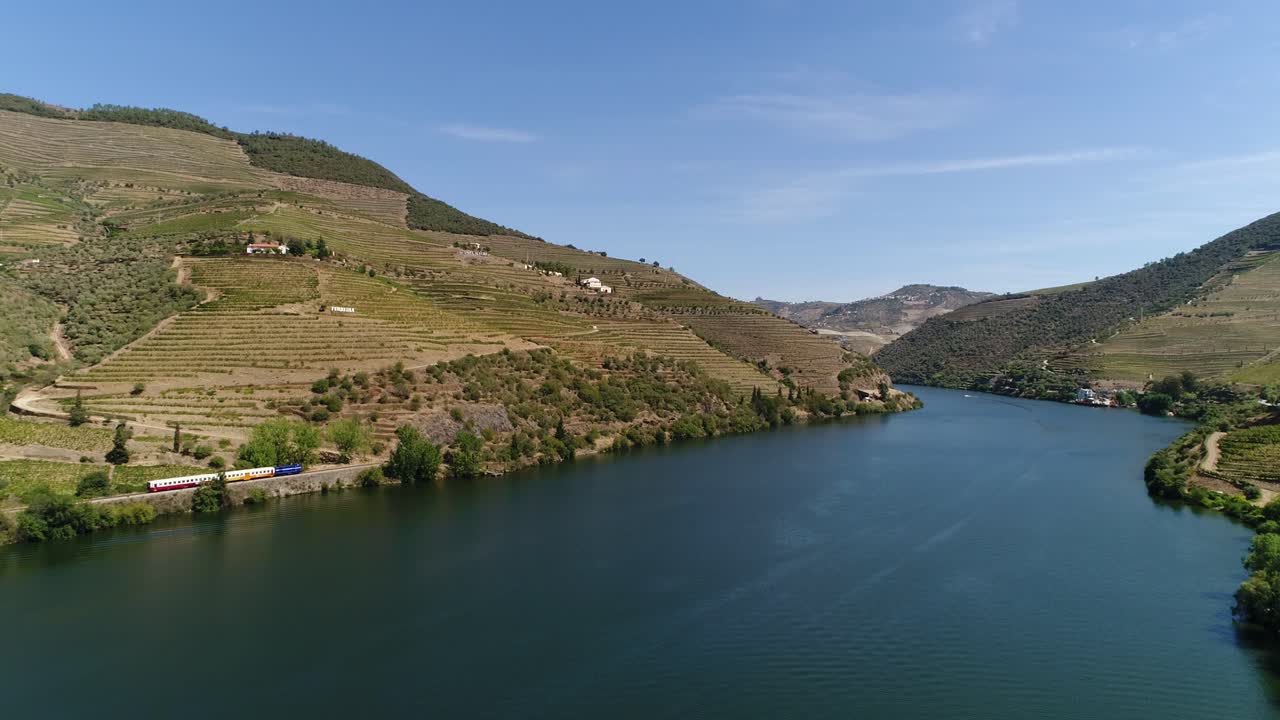 Train traveling on the banks of the famous douro river Portugal