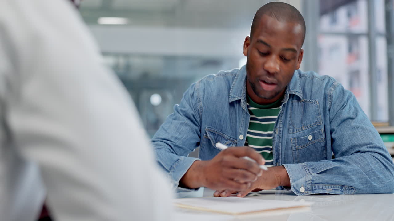 Black man, patient and writing in life insurance