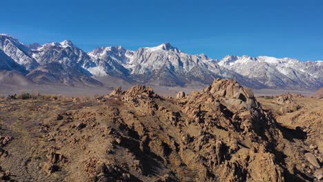 A-traveling-aerial-shot-reveals-the-snow-capped-Eastern-Sierra-Nevada-mountains-and-Mount-Whitney-in-snow-winter-near-Lone-Pine-California