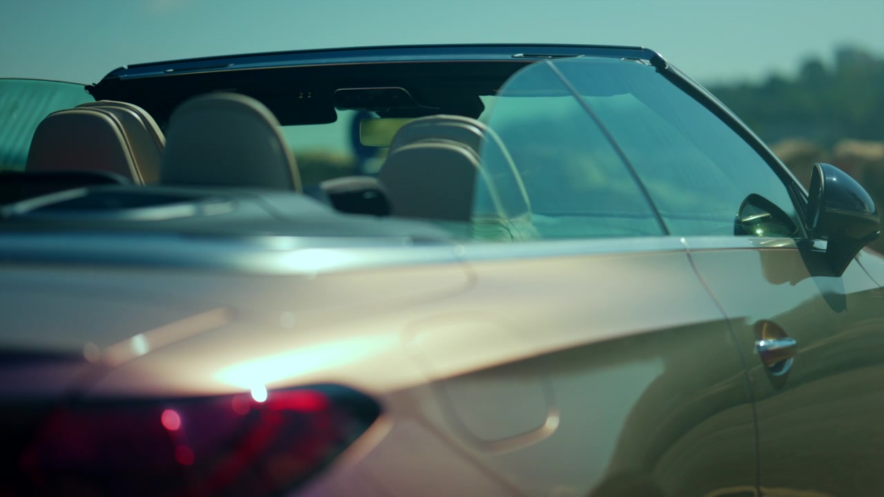 Convertible car moving on a highway, showcasing modern design and the lifestyle of freedom and travel under a clear sky