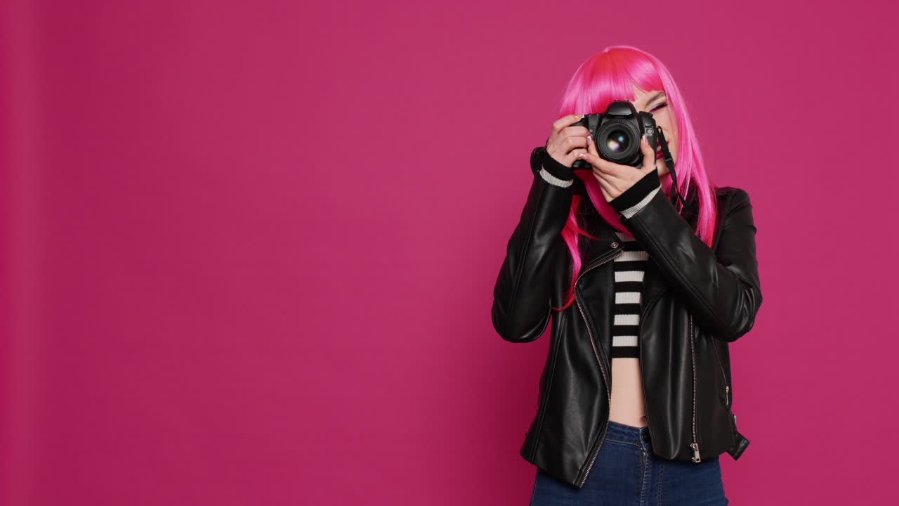 Attractive cool girl working with dslr camera as photographer