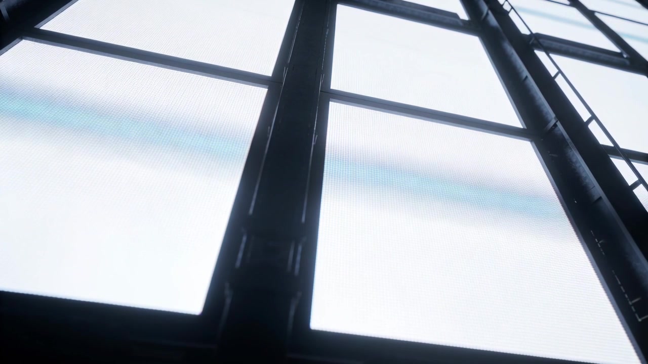 Cloud movement causing skylight showing shifting shadow bands in factory interior, ladder, mullions