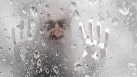 creepy face seen through glass of wet shower wall