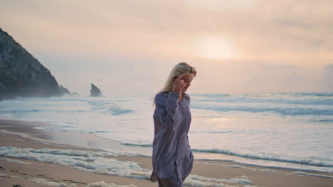 girl walking sunset coast in summer. happy tourist spinning camera enjoying trip